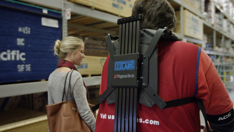 two people walking through workspace
